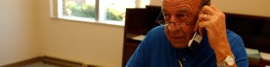 Photo of a man on a cell phone via 50 Plus Marketplace News for northern Colorado seniors.